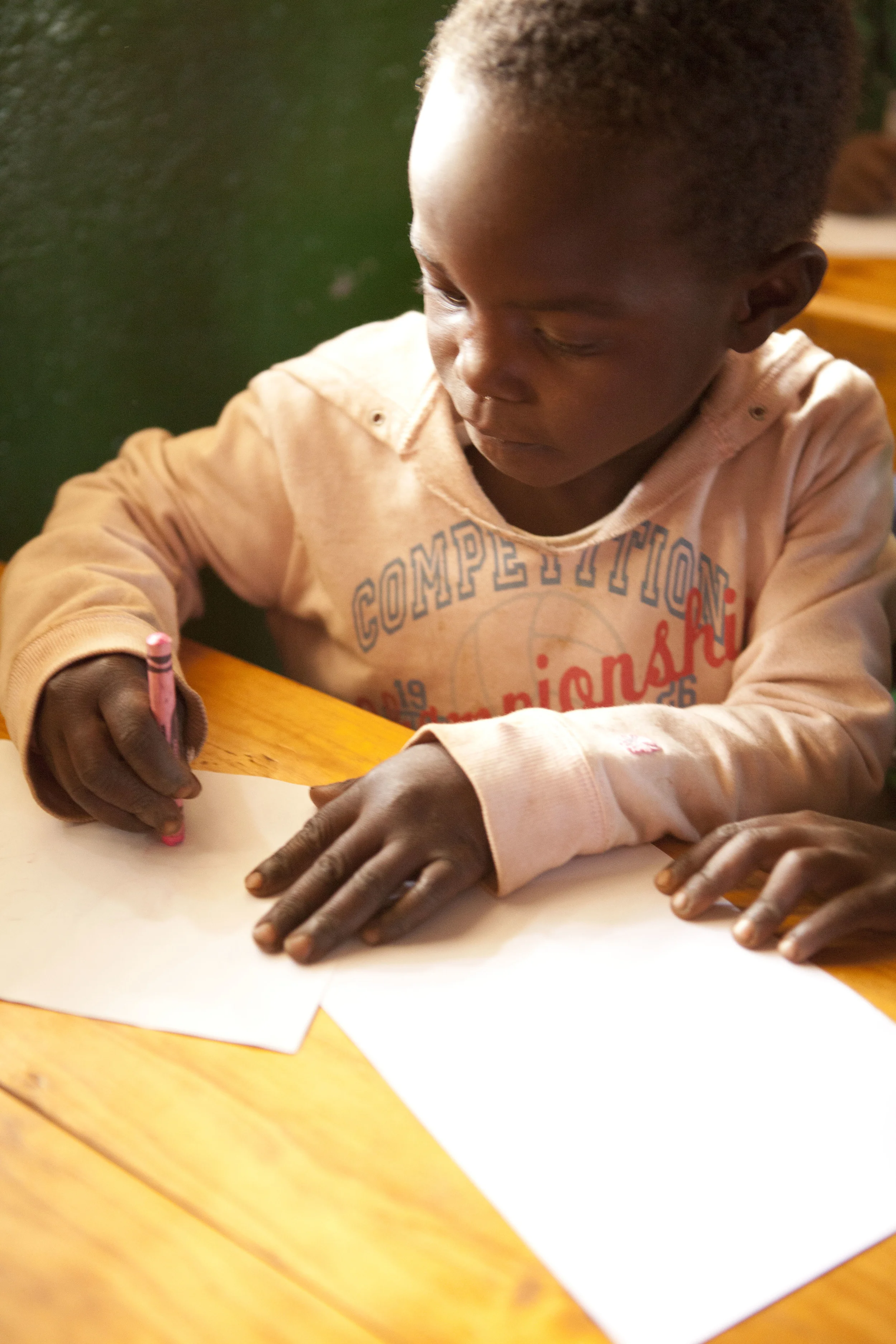 Malika working hard on a letter to her sponsor. 
