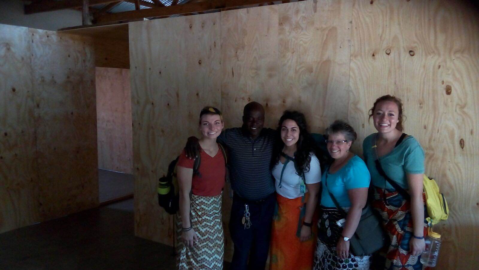 Our medical team and Pastor Phiri in front of the new walls in the clinic! We are building these as dividers for our large room to make it into an exam room, treatment room, and waiting room.