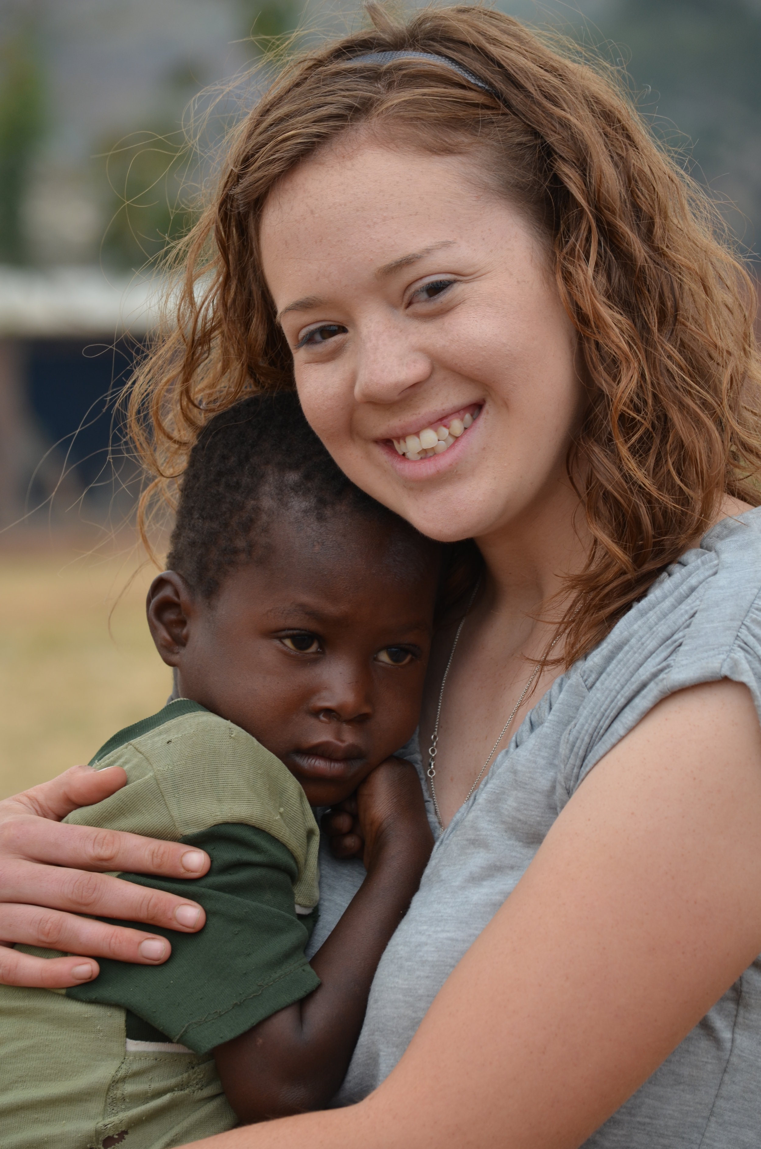 Kaitlyn Miller, 2011, holding another child with severe anemia.