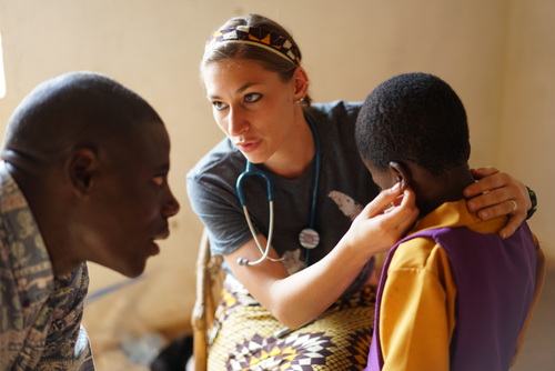 Karly Glibert working with Mr. Jairus in the clinic doing well-child exams.