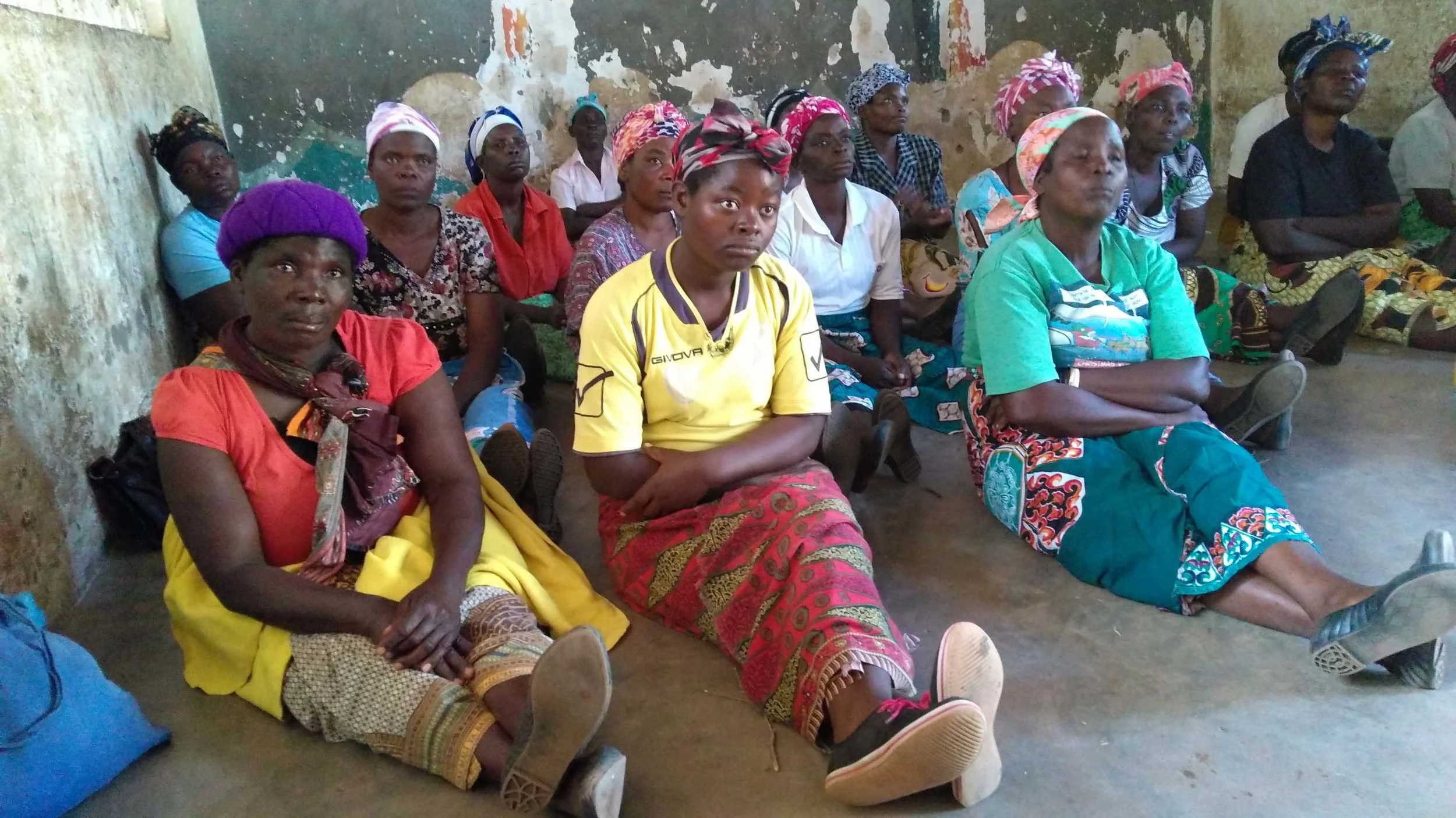 Mothers from Timothy’s and Patricia’s Homes learning how to watch for fevers and when to take kids to the hospital.