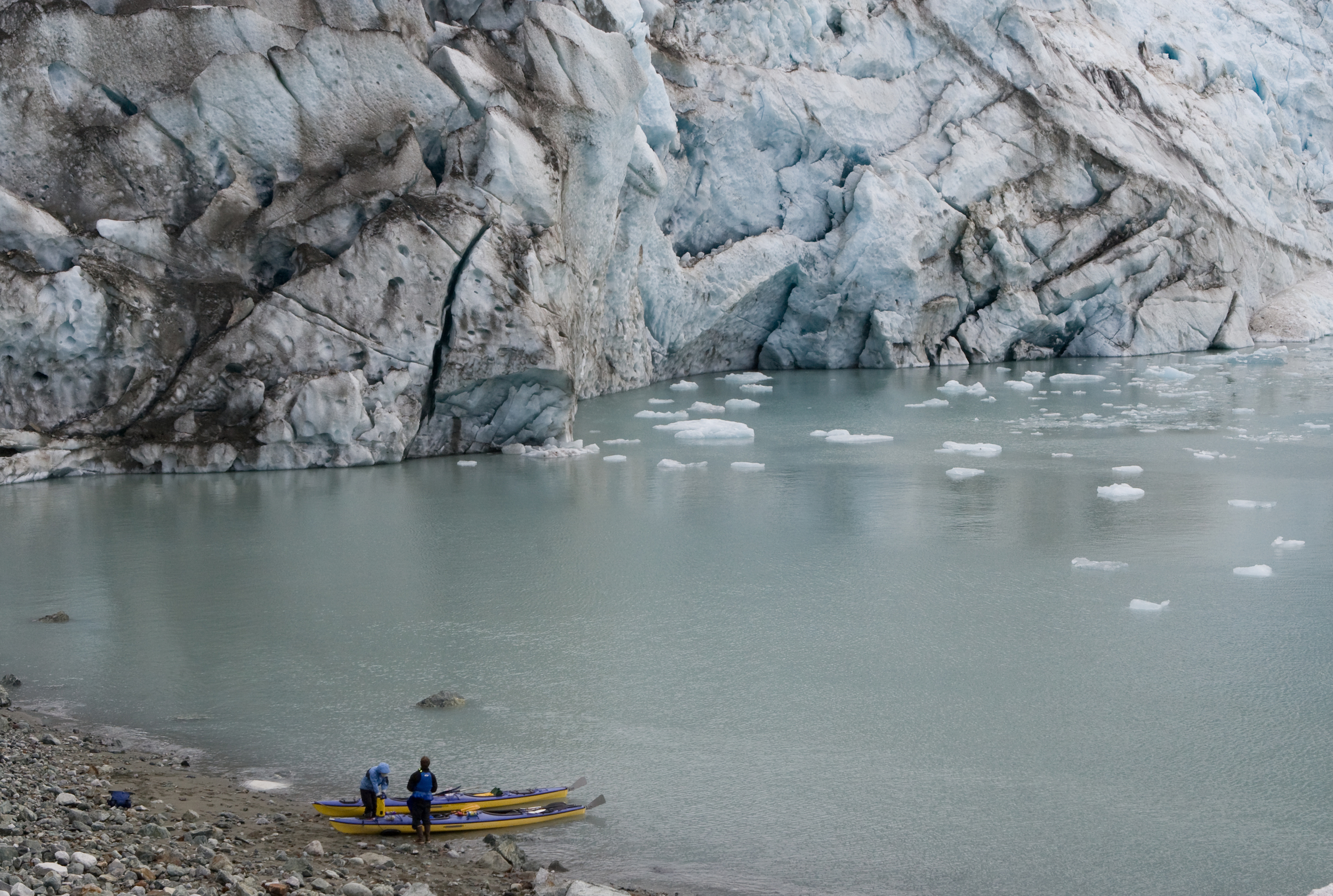  Paddlers land on the beach near Lamplugh Glacier while exploring Glacier Bay National Park by kayak. 