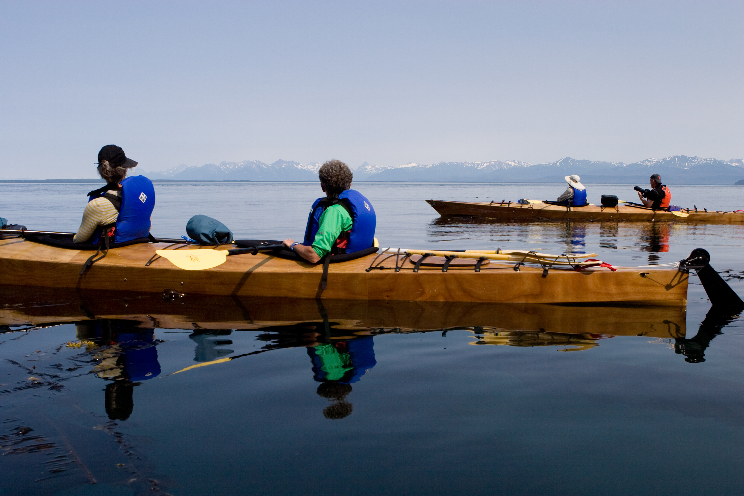  A group of kayakers watch the waters of Icy Strait for signs of humpback whales. &nbsp;Chichagof Island, Alaska. 