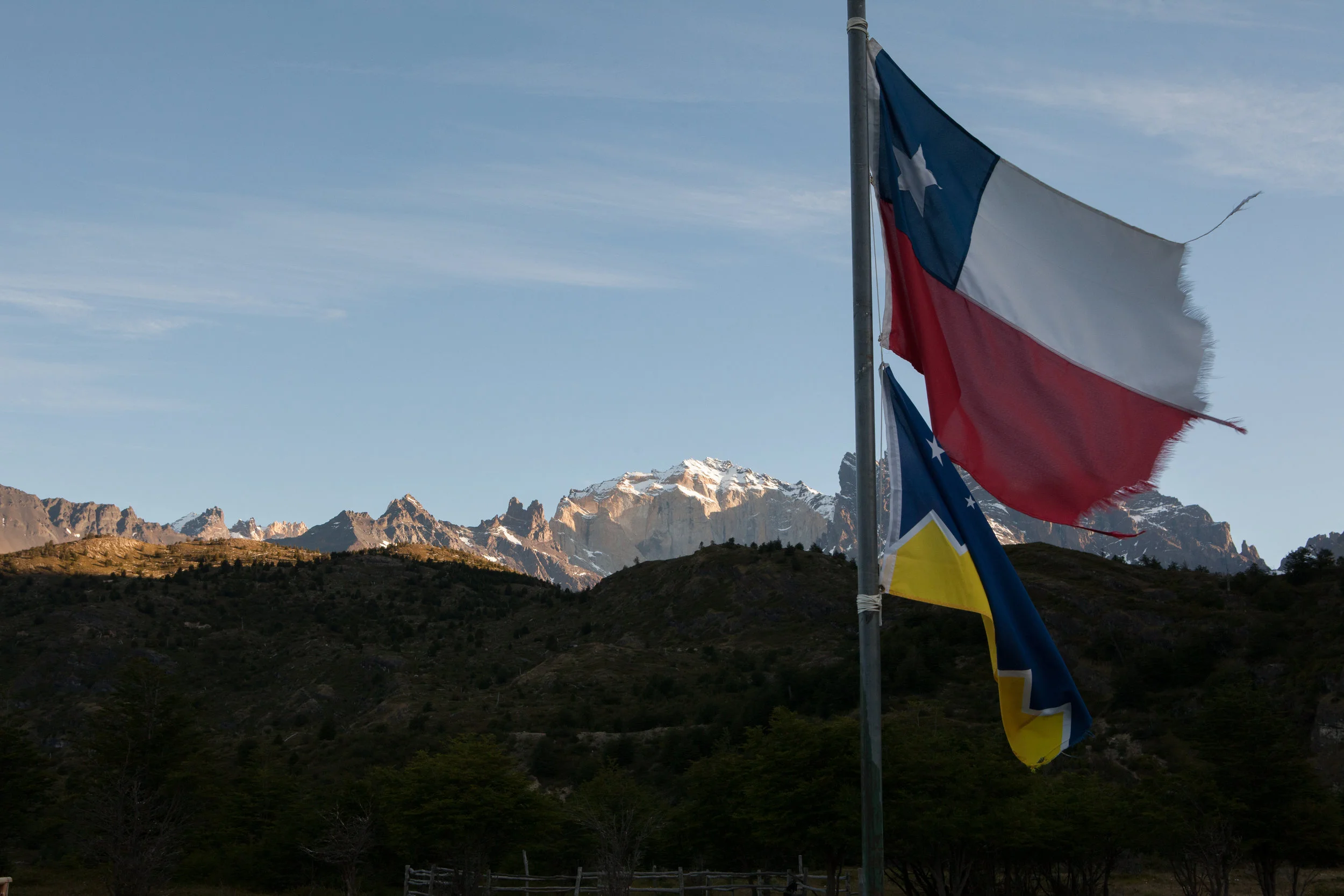 The national flag of Chile, and the flag for Patagonia flutter in the evening air. The breeze was calm this night, but the frayed edges on the flag make me think that the winds get strong in this region - each fiber shaped by the pull of the current of air. 