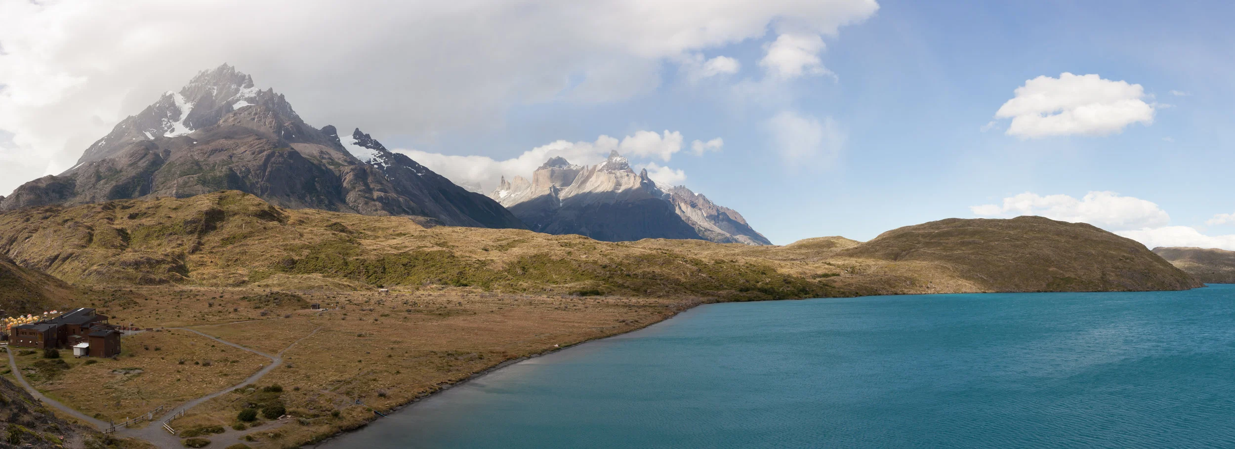 Peho é Lake sits below the Paine Grande Peak with Cuernos del Paine in the background. 