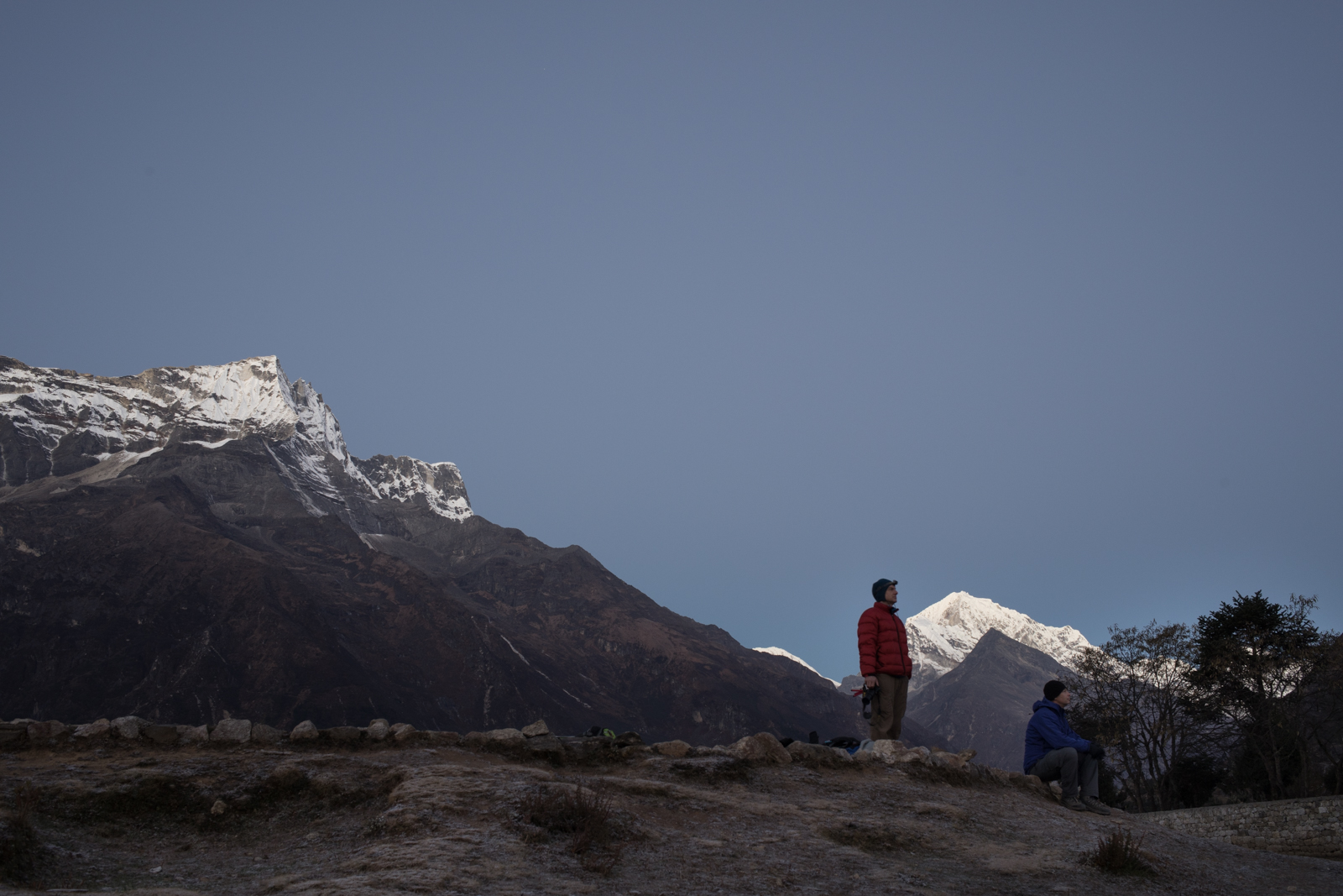 Ambrose and Russ watch the horizon as the sun rises and brings light to the Everest valley. 