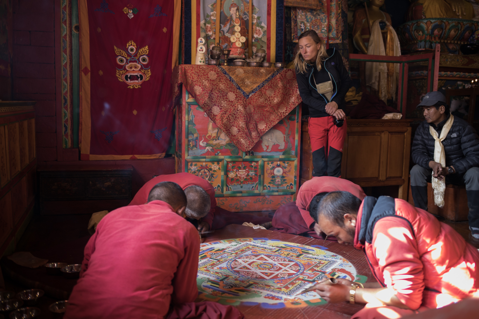 Monks sift pigmented sand in delicate lines to slowly create a mandala. During our visit to the monastery, we had the privilege of attending a session of prayer where we sat while the monks chanted prayers and prepared offerings. We presented a silk kata to the Head Lama of the monastery and he blessed us for our continued journey by placing a small piece of wood on our heads and draping the silk around our shoulders. We sat and listened to the chants. The chamber where the monks prayed had hundreds of beautifully painted frescos and thousands of delicately carved images in the wood panels that made up a tiered sculpture in the center of the room. We stayed maybe half an hour and it wasn't enough time to take in all of the beauty. 