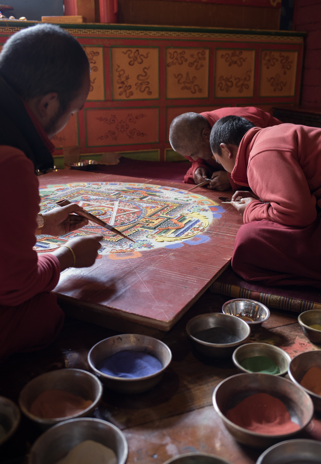 Grain by grain the mandala is formed. The work of art is an act of meditation. A ceremony had been scheduled two weeks out to sweep away the image and celebrate with the community. A temporary beauty. Our guide said that many people would come to the monastery for the ceremony and dancing. 