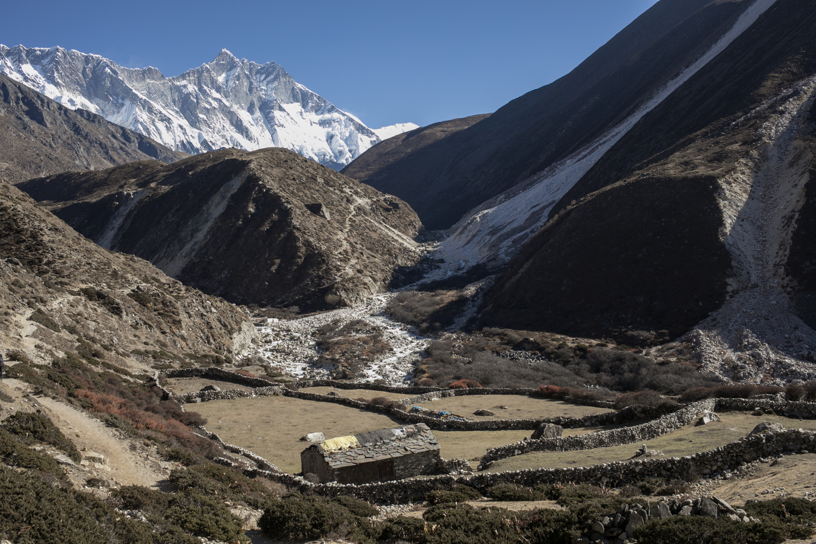 The same small farmhouse with a view up the valley. 