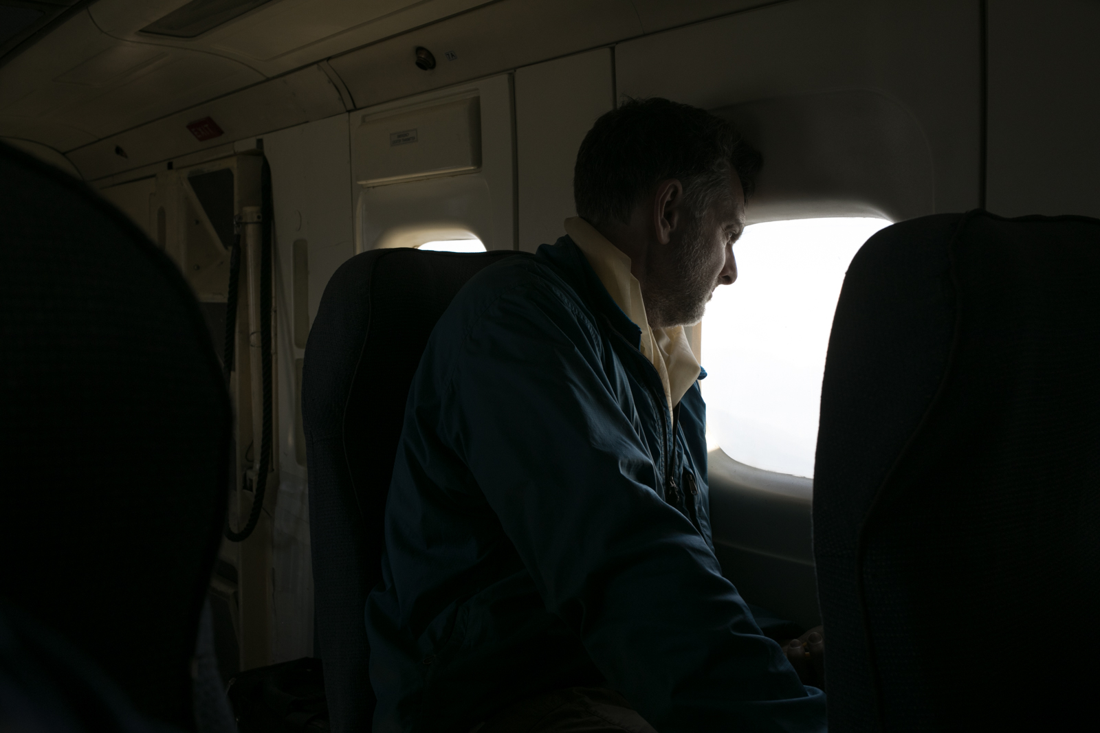 Ambrose enjoys a final moment watching the mountains as we fly from Lukla to Khatmandu. 