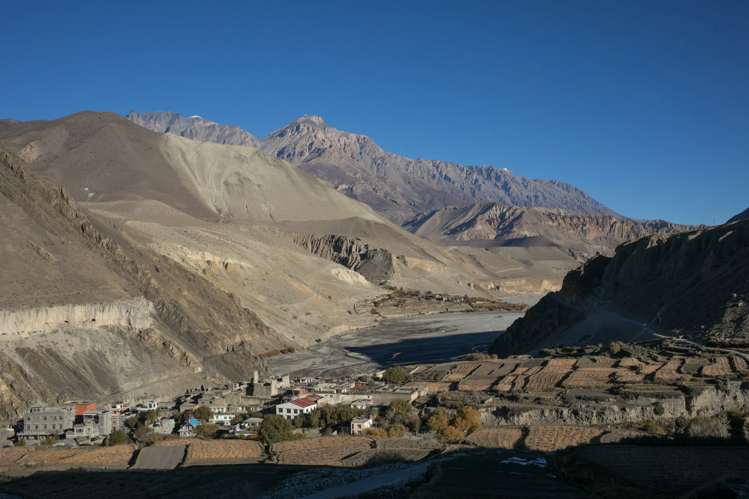 Small villages dotted the road. In the lower regions at the start of our trek the towns were surrounded by a patchwork quilt of different grains, vegetables, and apple trees. The harvest season had passed and we saw a few farmers preparing their land for the winter to come. 