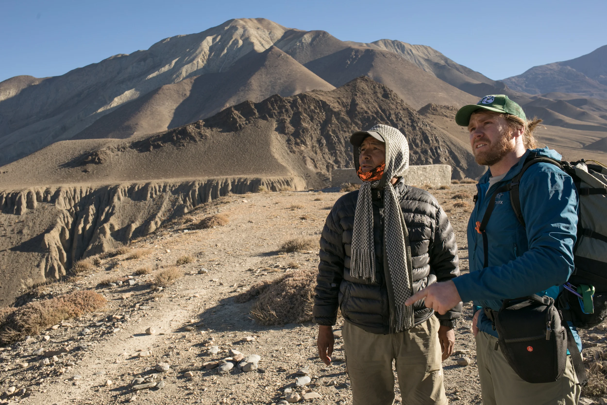 Our guide Lakpa Sherpa and Aaron discuss the geography of the region. The valley walls rise quickly and are a mixture of brown, red, orange, and yellow - a desert palate. 