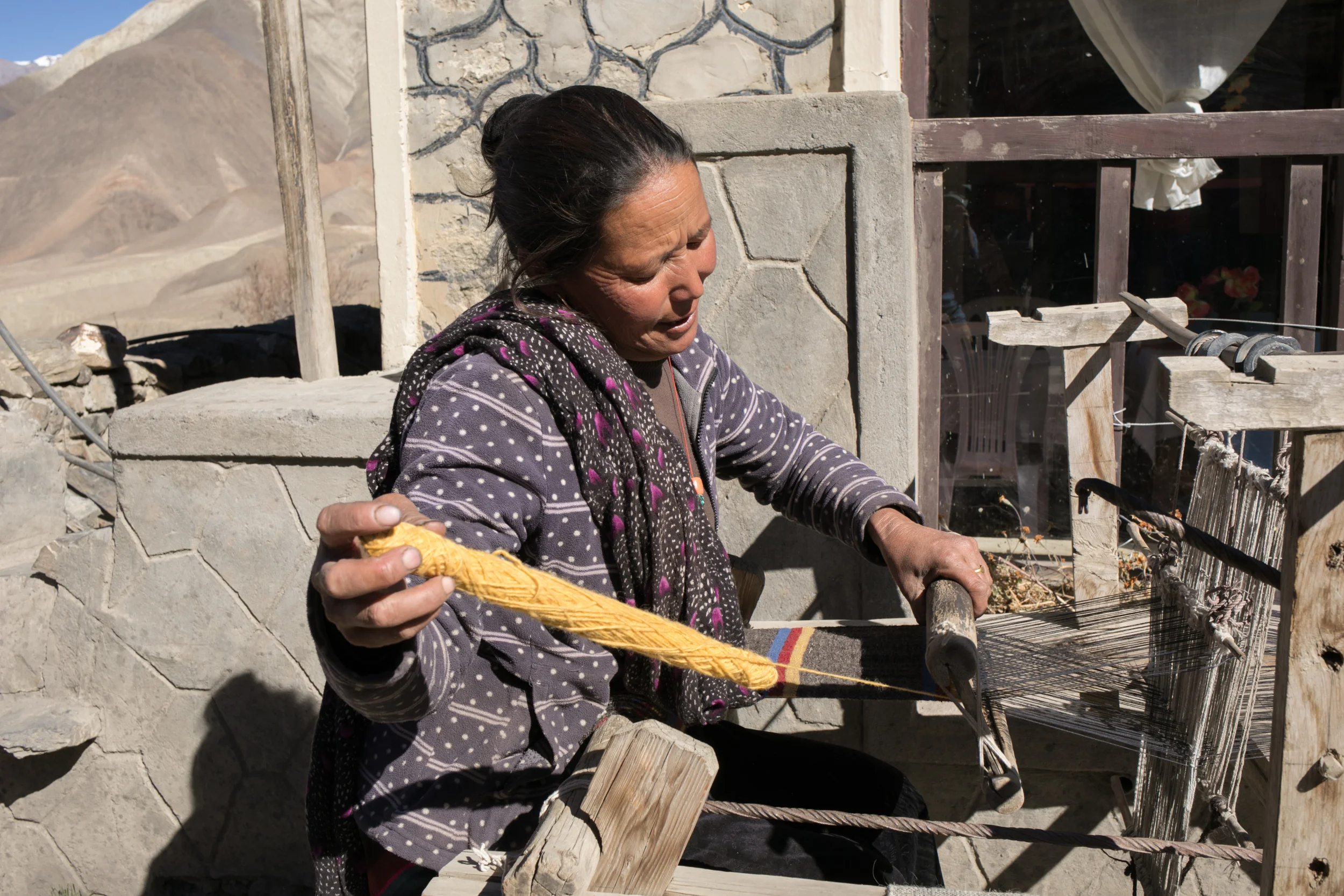 We stopped for tea in a small village Kunjok and spoke to a wonderful woman about her weaving. She had scarves, traditional belts, and blankets on display. She was in the process of weaving a yak wool scarf. 