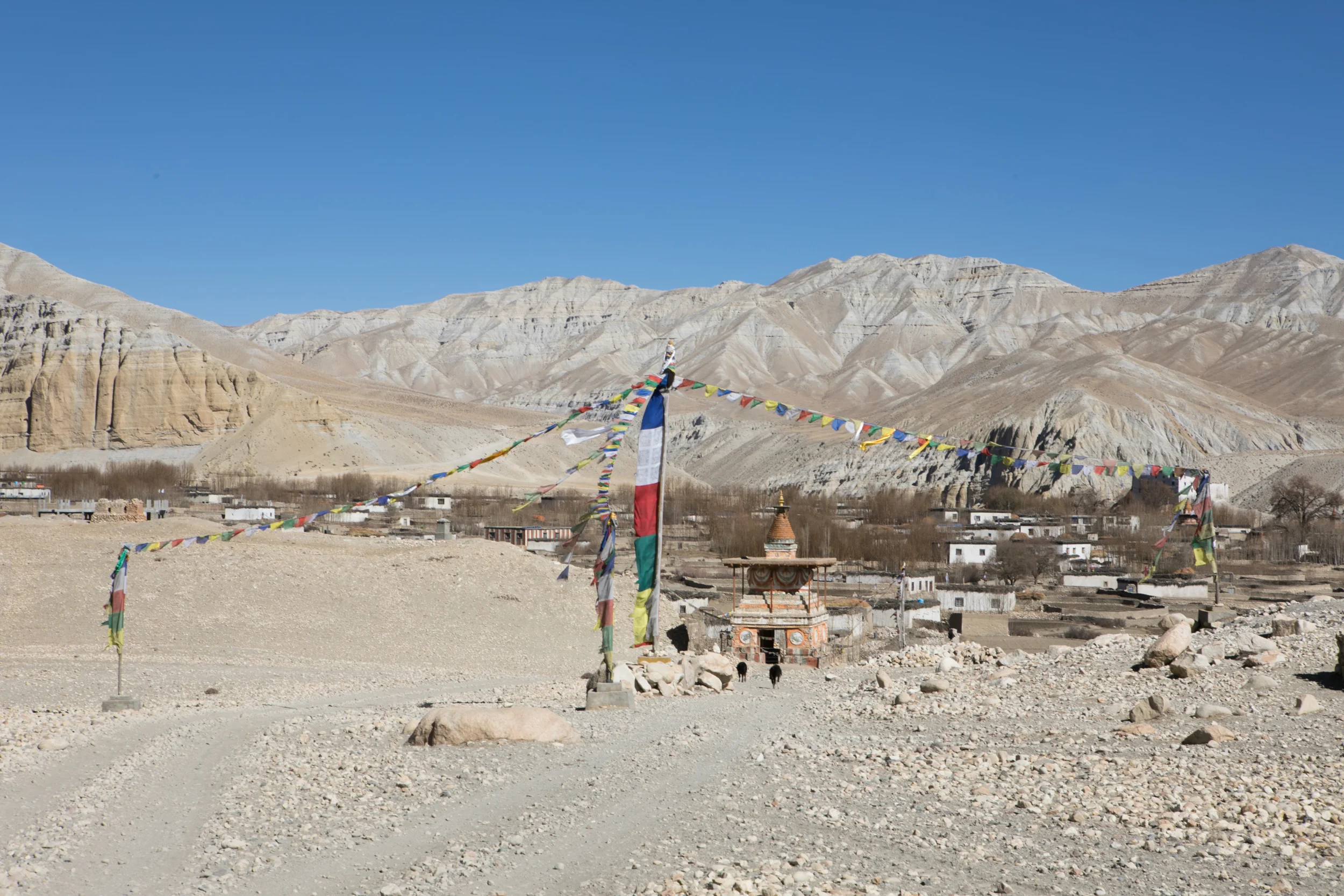 A large chorten stands at the gate of Charang. 