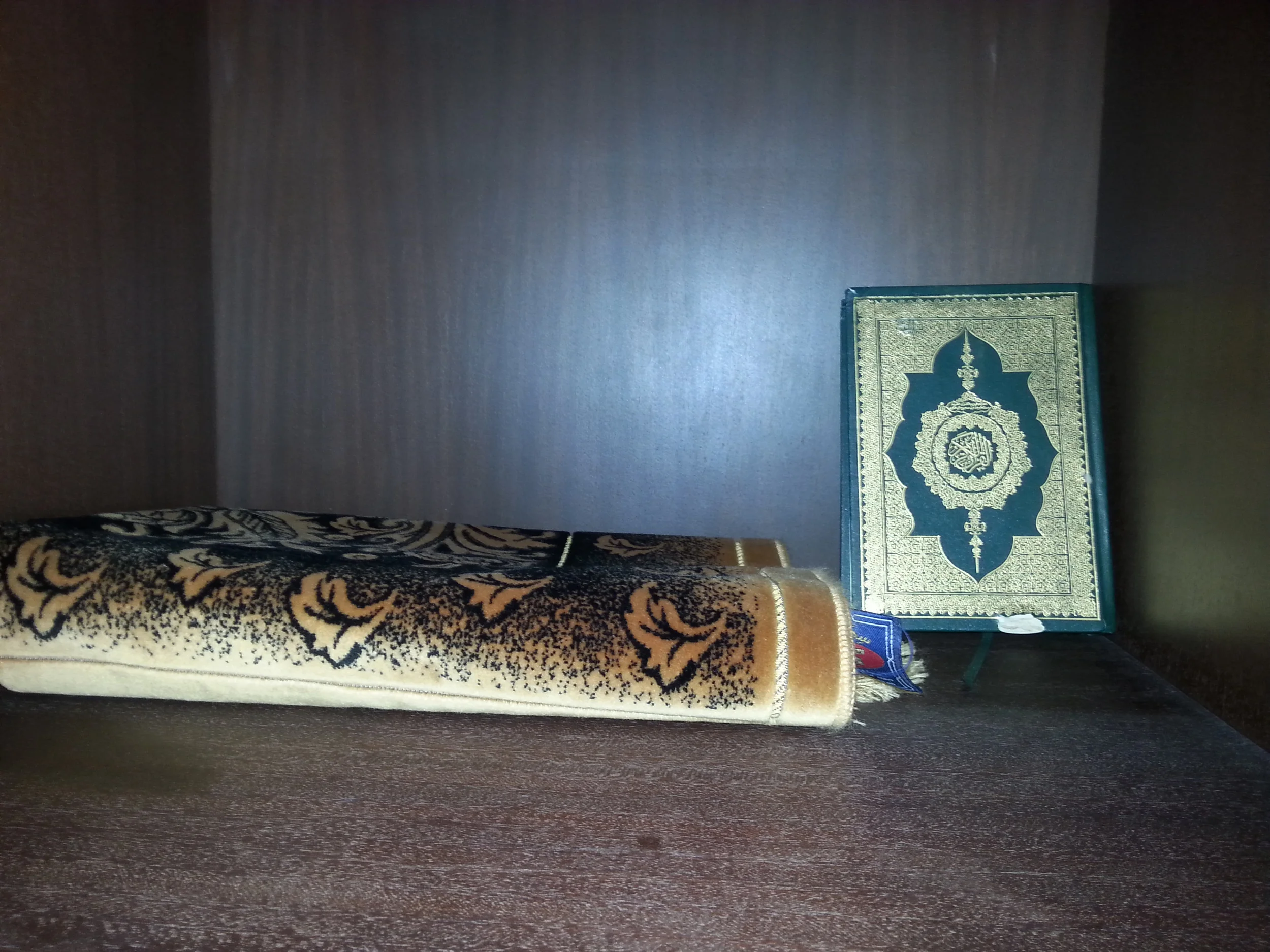 Islamic prayer rug and Qu'ran.
