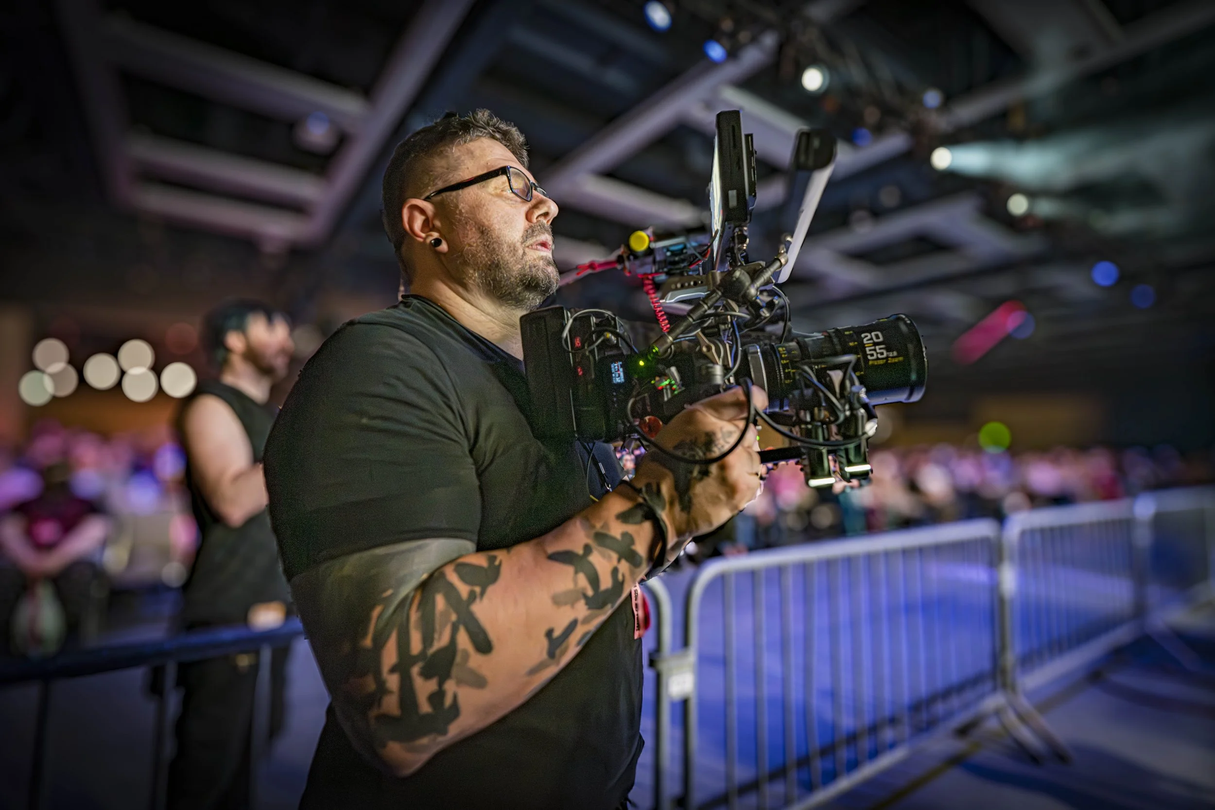 Video production worker holding video camera at live event