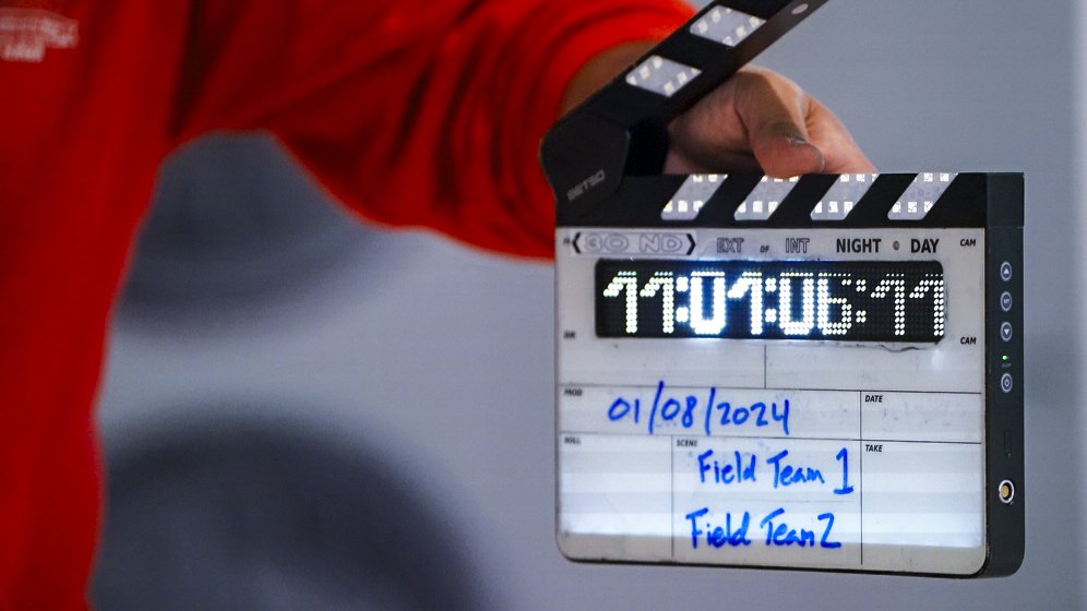 Person holding video production clapper.