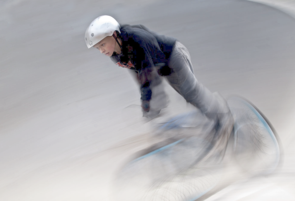 Panning with a kid on a bike - I let the kid go back and forth from my left to my right. I set the camera with an aperture of f16, Shutter speed of 1/160th of a second, ISO200. I set the camera to continual focus and set the shutter to take continual photos. I took 20-30 photos each pass keeping my focal point on the chest of the kid.