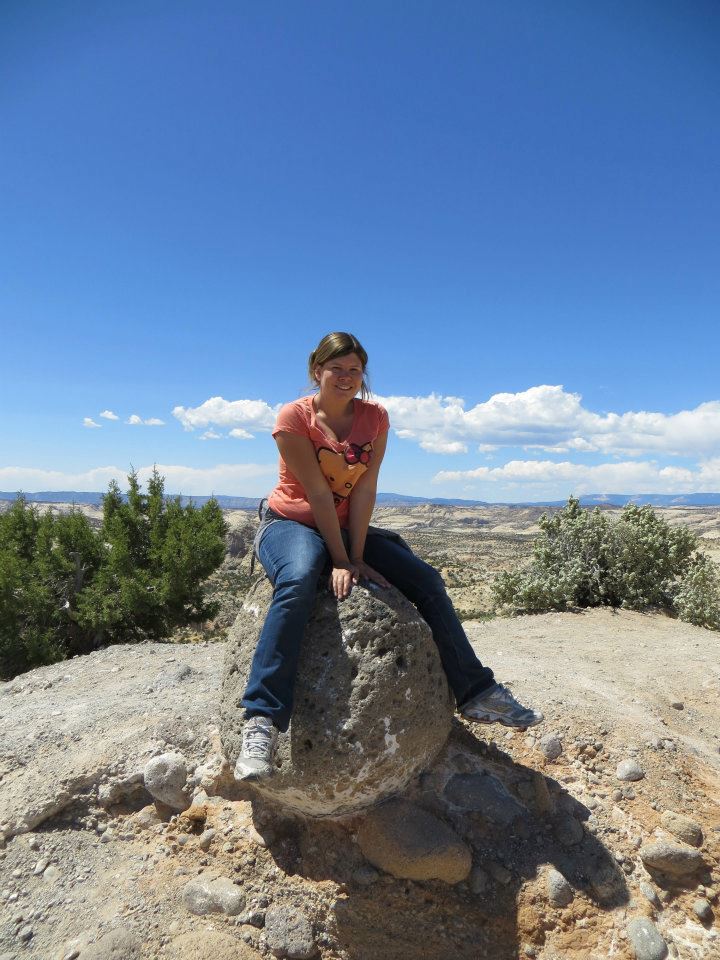 Sitting on a rock during a rest stop.