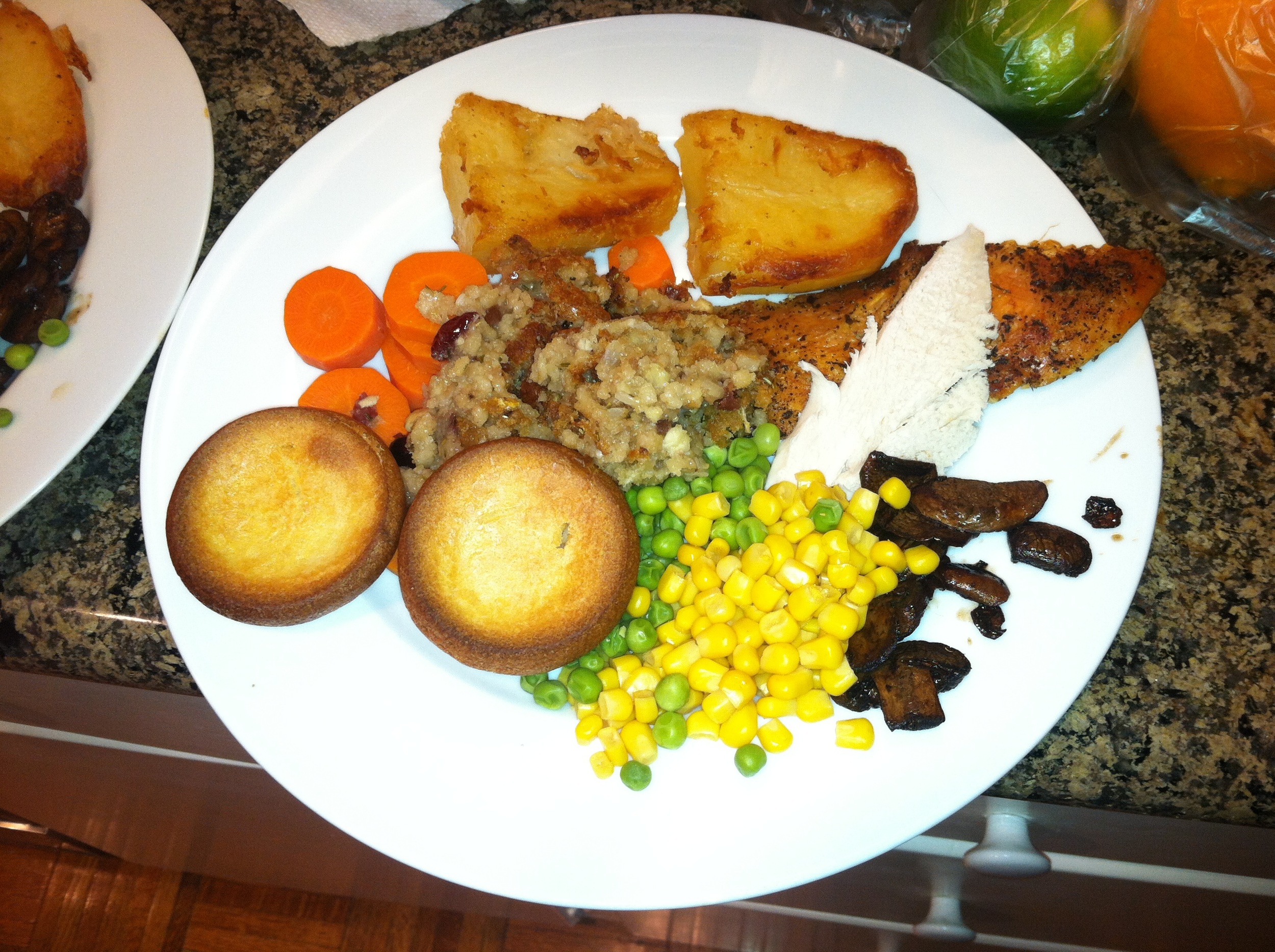  Christmas dinner- Turkey, Yorkshire pudding, sautéed mushrooms, roasted potatoes, carrots, peas, stuffing and corn. Not pictured- English sausages wrapped in bacon. 