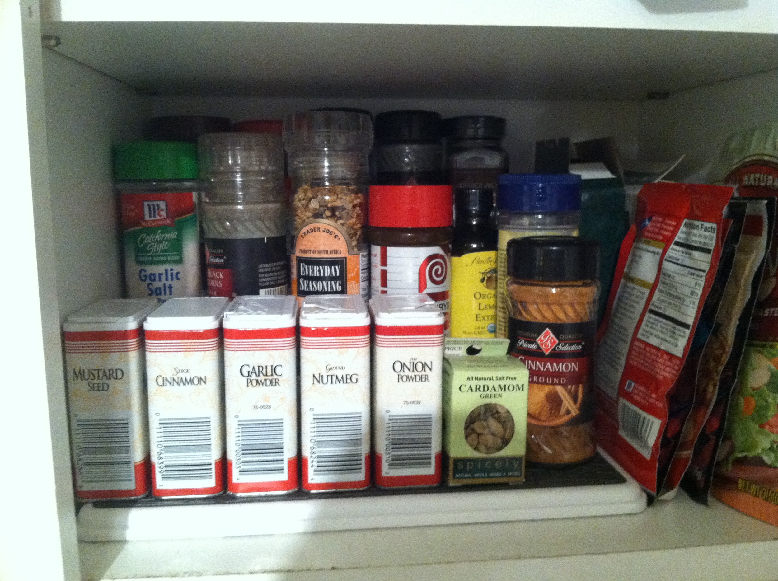  The spices on the tiered shelf. It's a bit difficult to see the ones on the highest tier, but it's still a better solution to having everything crammed on the shelf. 
