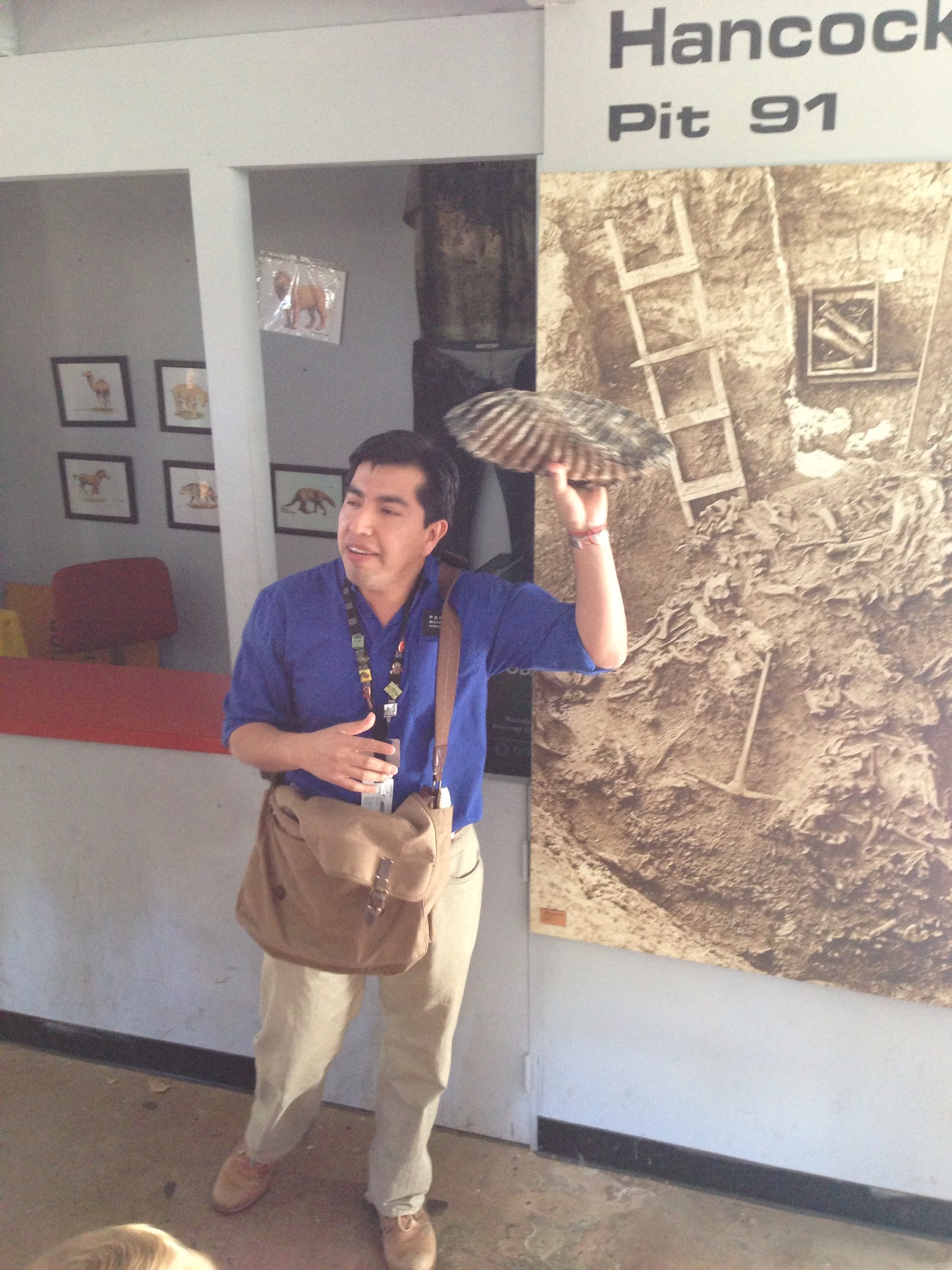  Gustavo holding up a giant molar. These are the big bones that are currently being left to sit in the tar, while they work on the micro-organisms. 