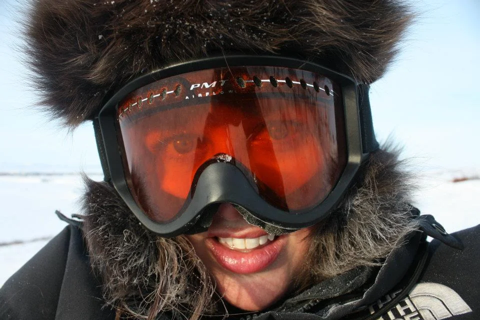 Donning ski goggles for my first snowmachine ride in Alaska.