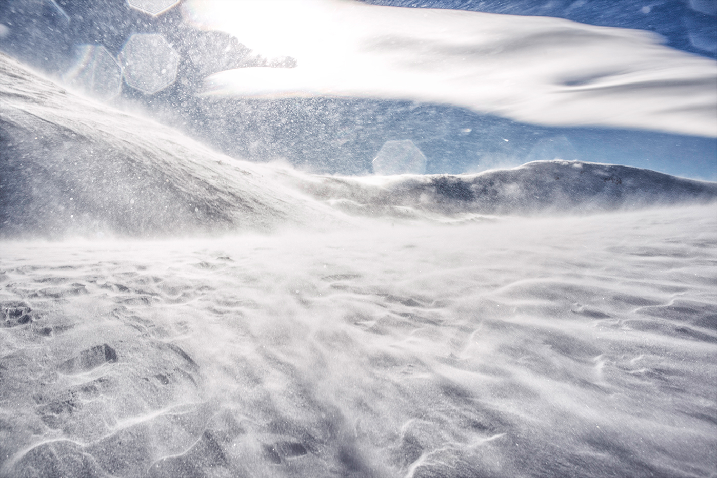 Out for a hike on Loveland Pass, dressed in insulated snow-proof garb from head to toe, I found myself waist deep in the white stuff trying to capture the exhilarating experience of 60mph winter winds across the snowy surface.