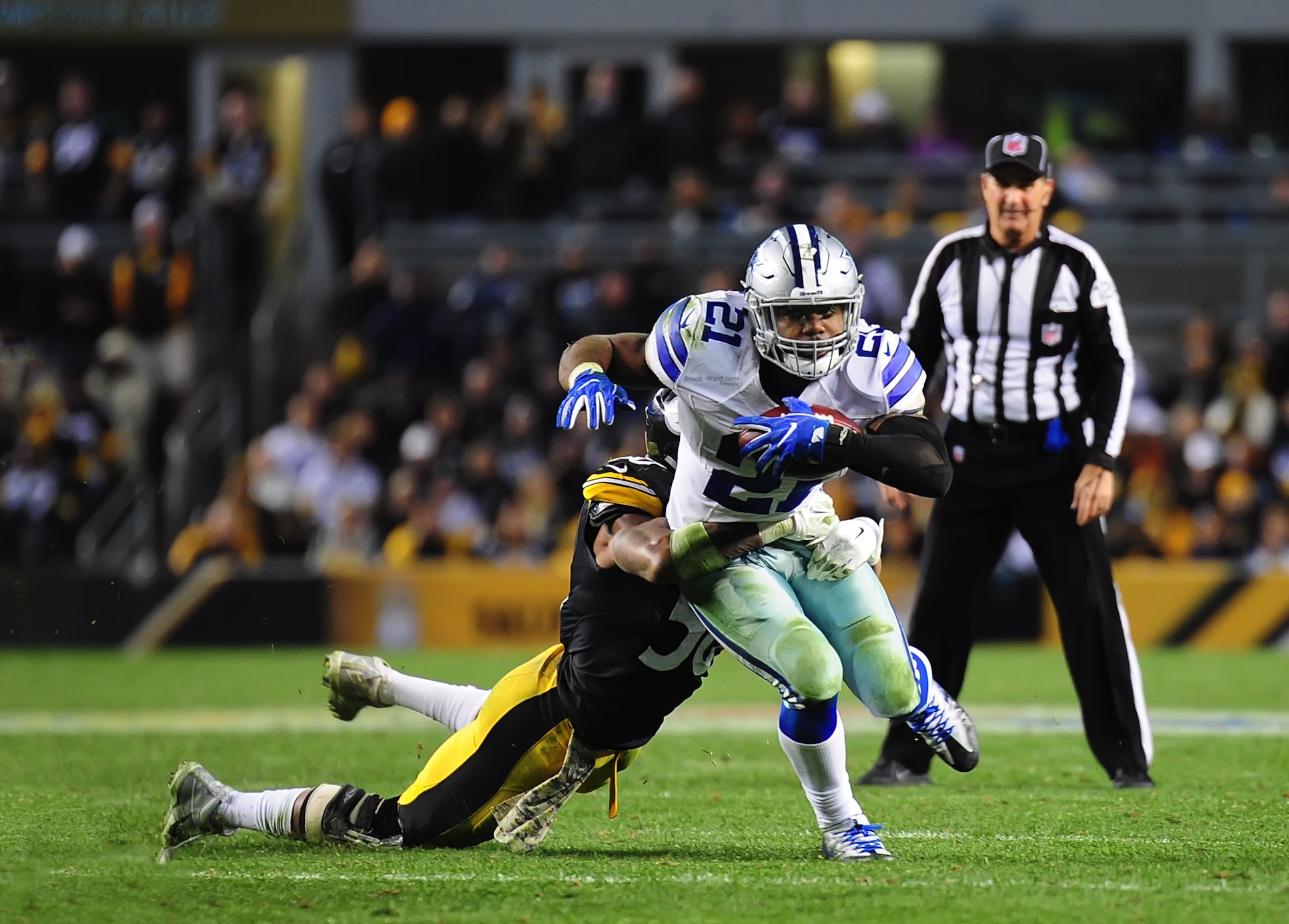 Ezekiel Elliott finishing a strong run against the Steelers defense.