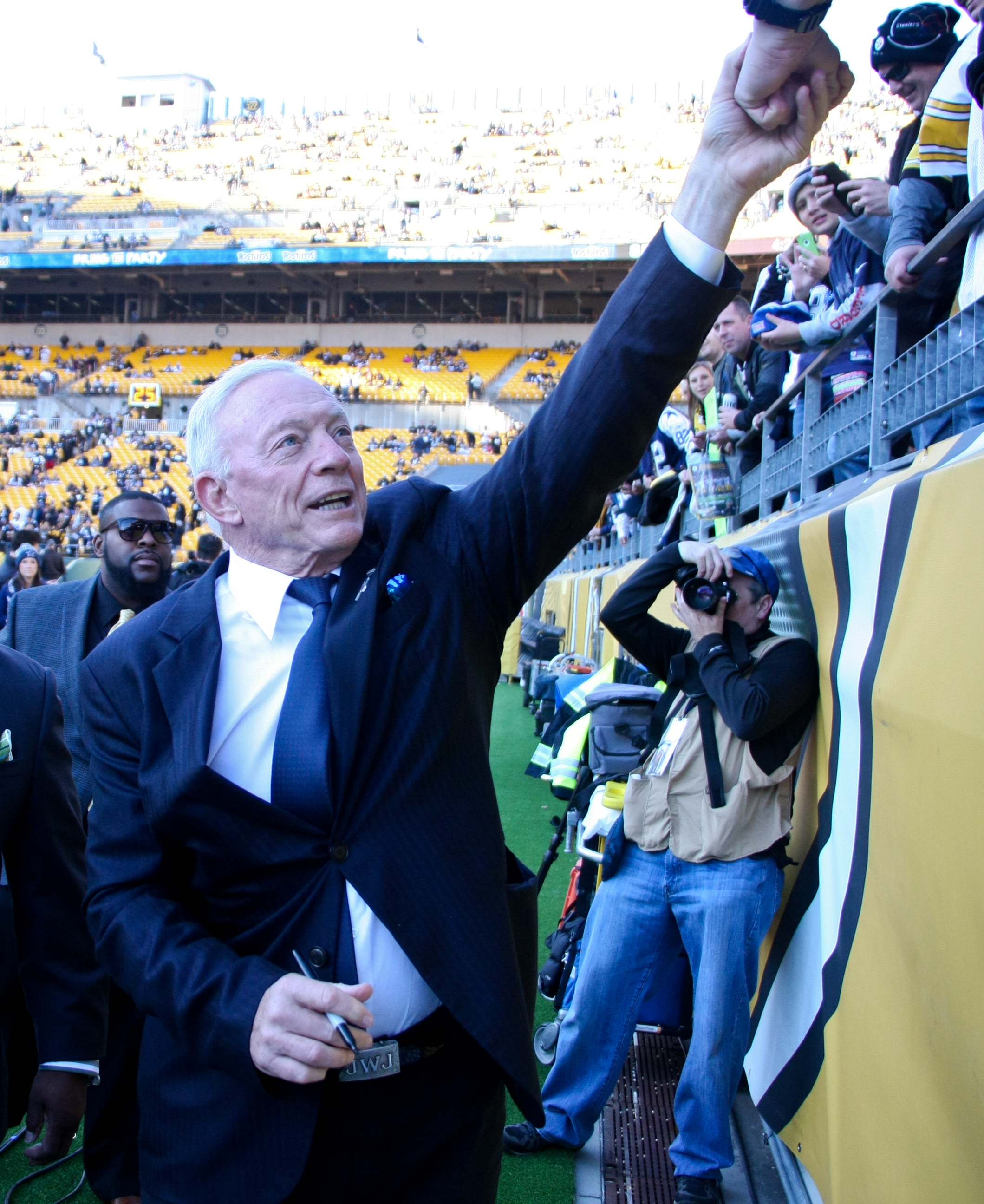 Jerry Jones with me in the back ground (tan NFL Media vest and camera in front of my face)