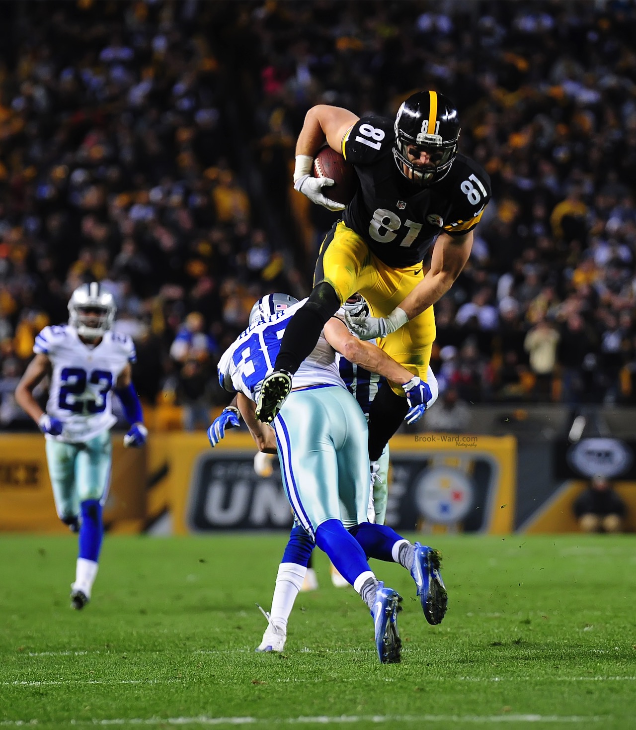 Jesse James leaping over a Dallas defender