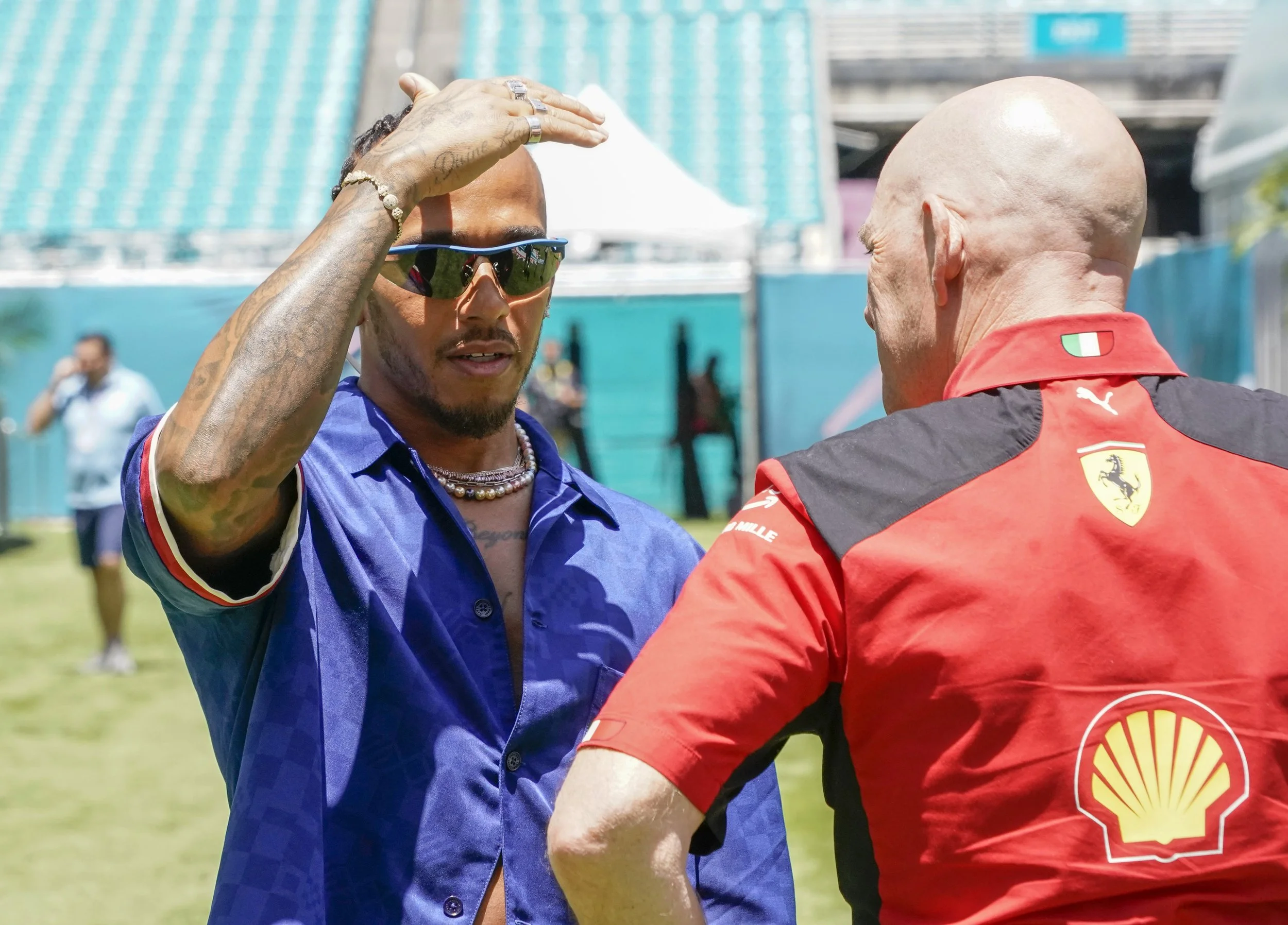Lewis Hamilton talking to a Ferrari team official
