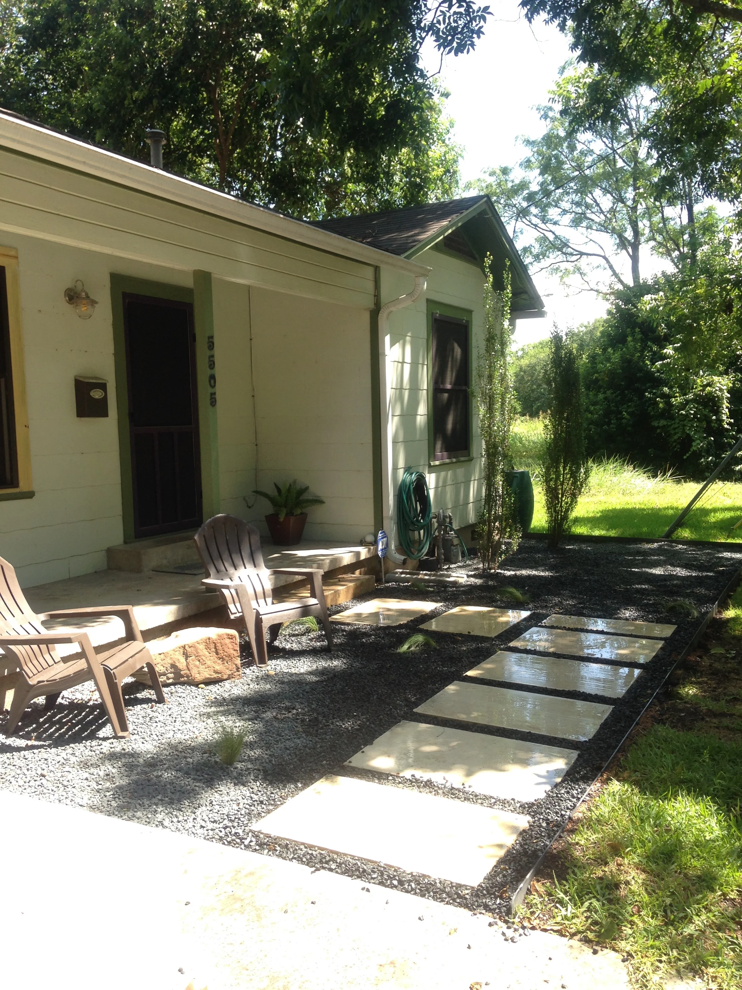 House exterior with gravel pathway and patio chairs