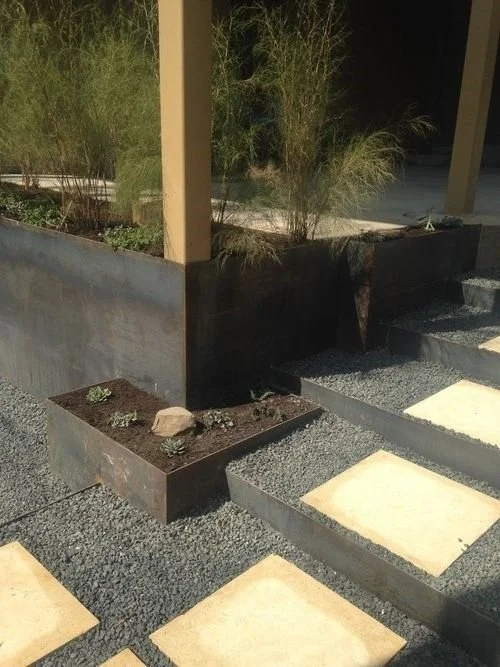 Steel Retaining walls with modern lueder stepping stones.