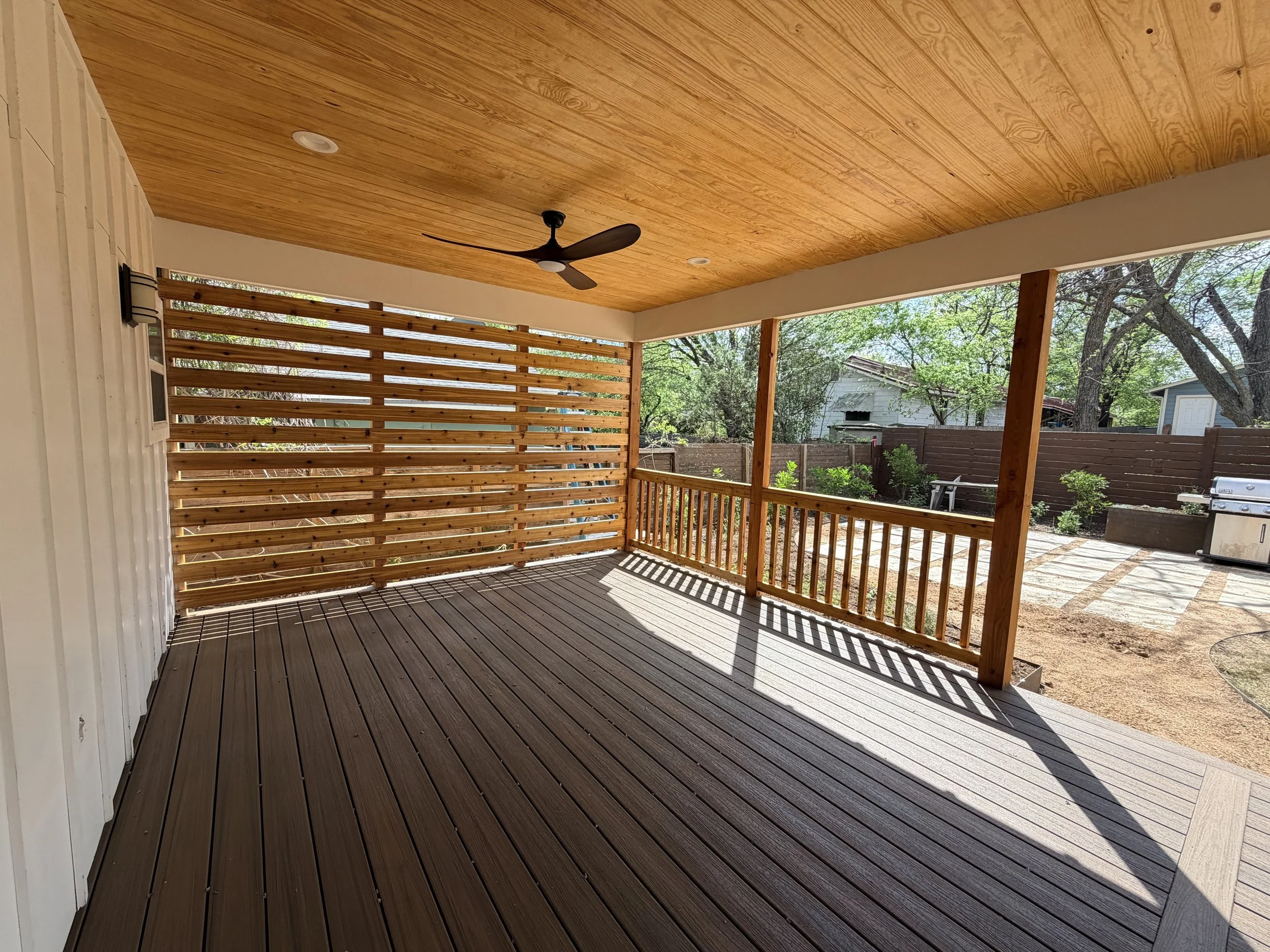 Custom Trex decking and extended patio with pine tongue and groove roofing.