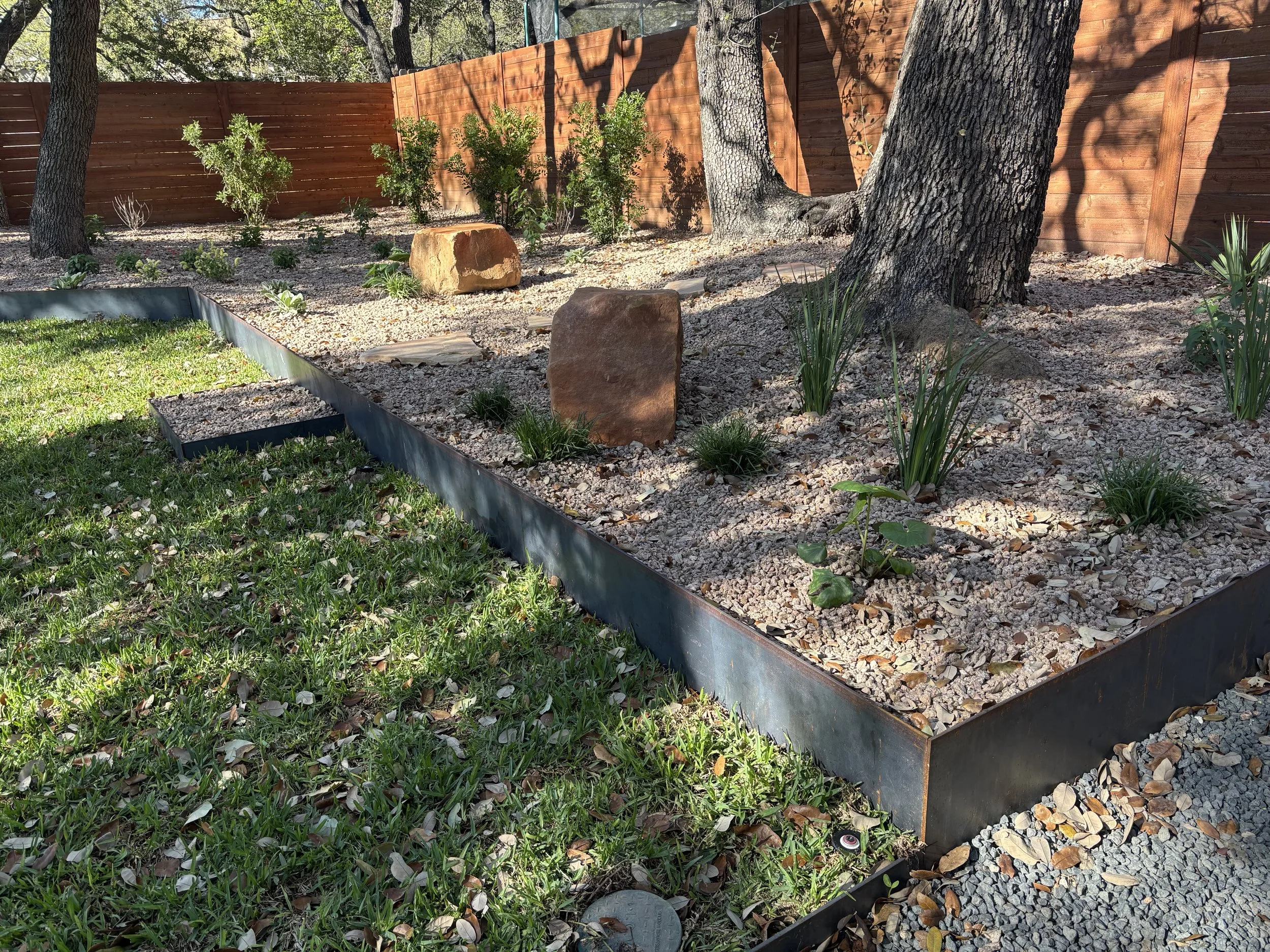 Raised steel planter with crush granite and native plantings