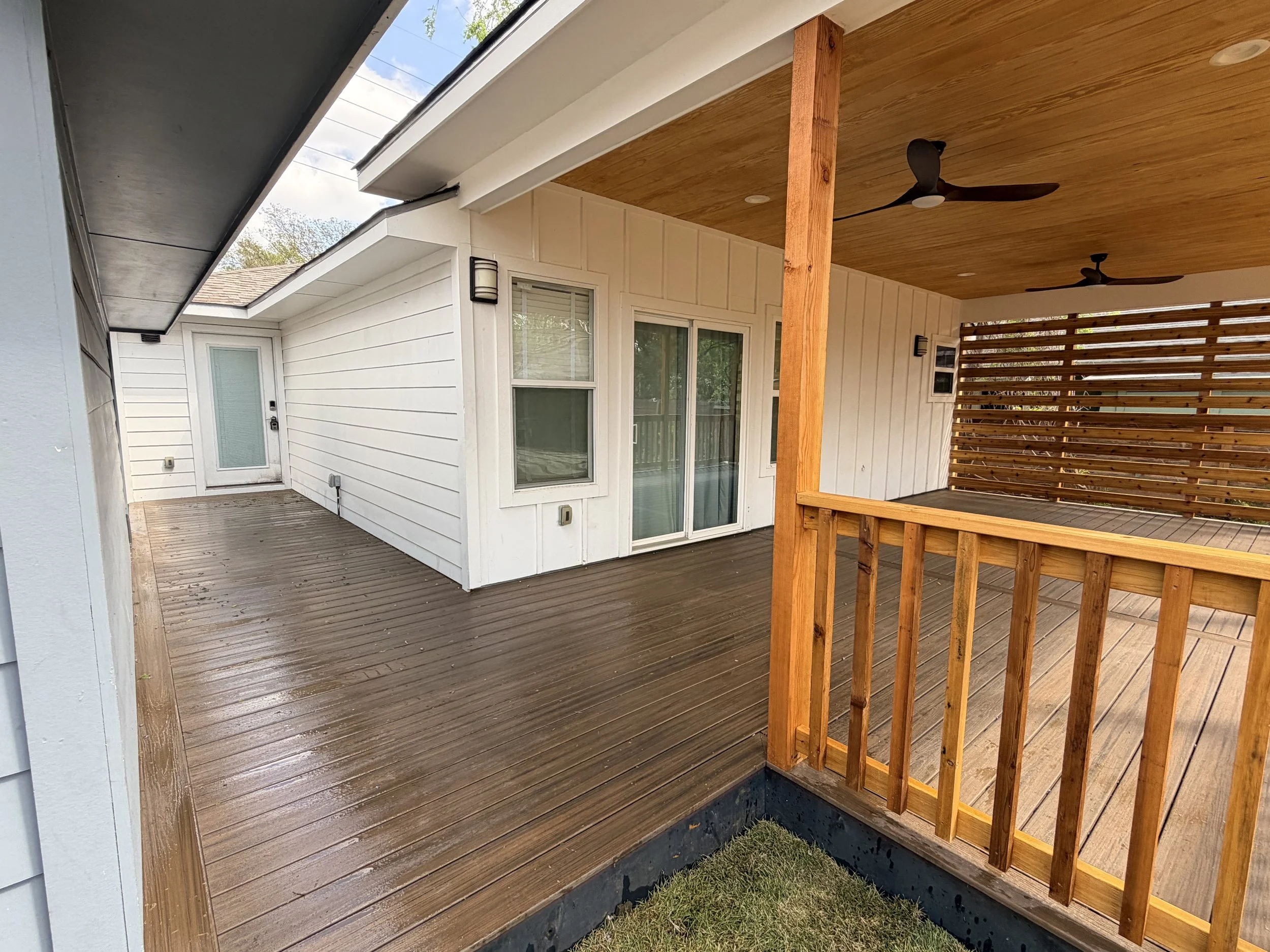 Custom Trex decking and extended patio with pine tongue and groove roofing.
