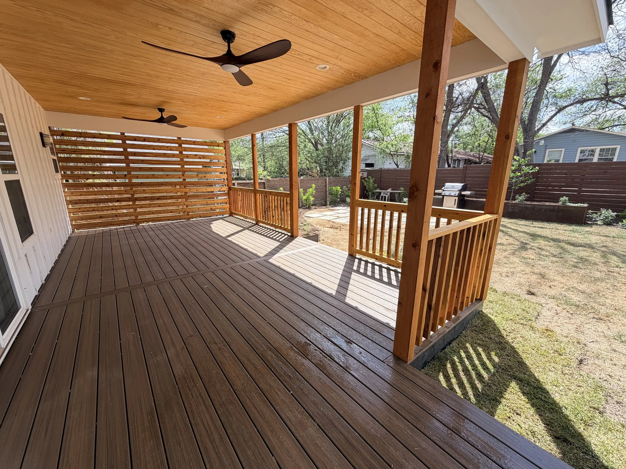 Custom Trex decking and extended patio with pine tongue and groove roofing.