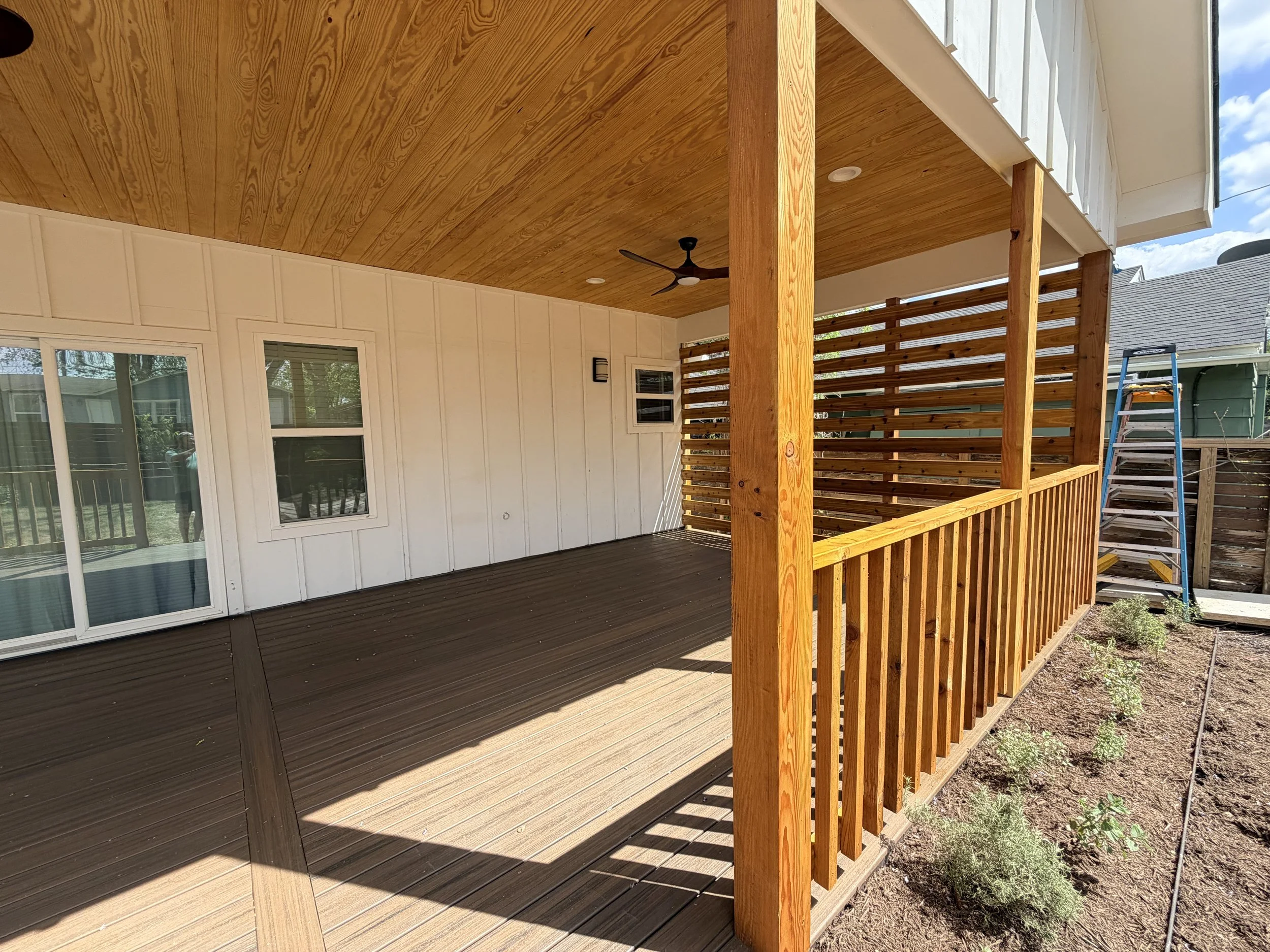 Custom Trex decking and extended patio with pine tongue and groove roofing.