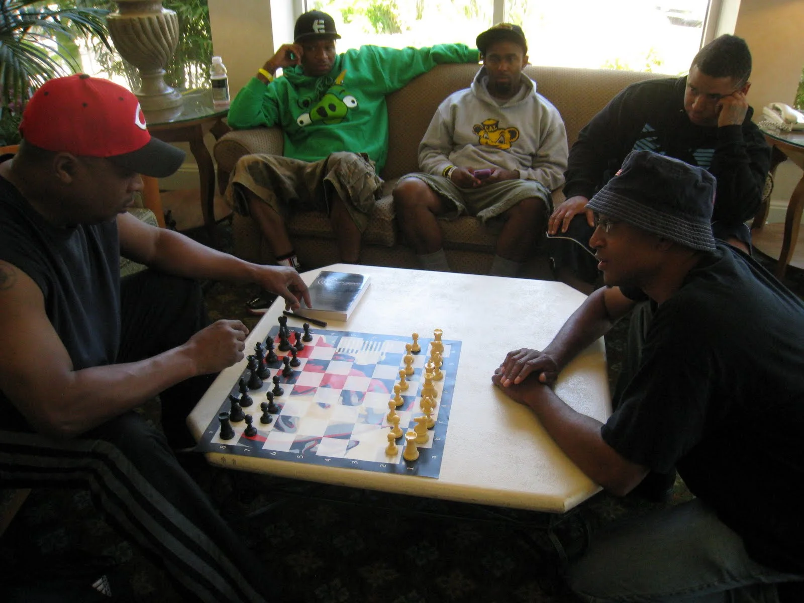 Chuck D of Public Enemy and Adisa play a game on a Barack Obama board...