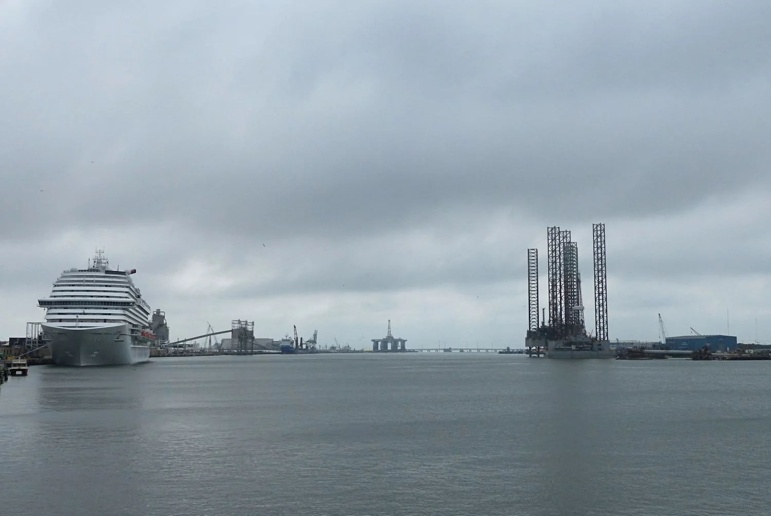 View down the channel. Carnival Cruise ship is docked and a semi-submersible and two-jack ups in for work.