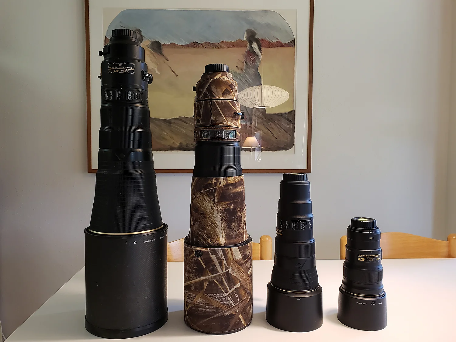 Bill’s ginormous 600 f/4, my 500 f/4 in camo, the new tiny 500 f/5.6 PF and the 300 f/4 PF lens. Art in the background by Margret Wallace