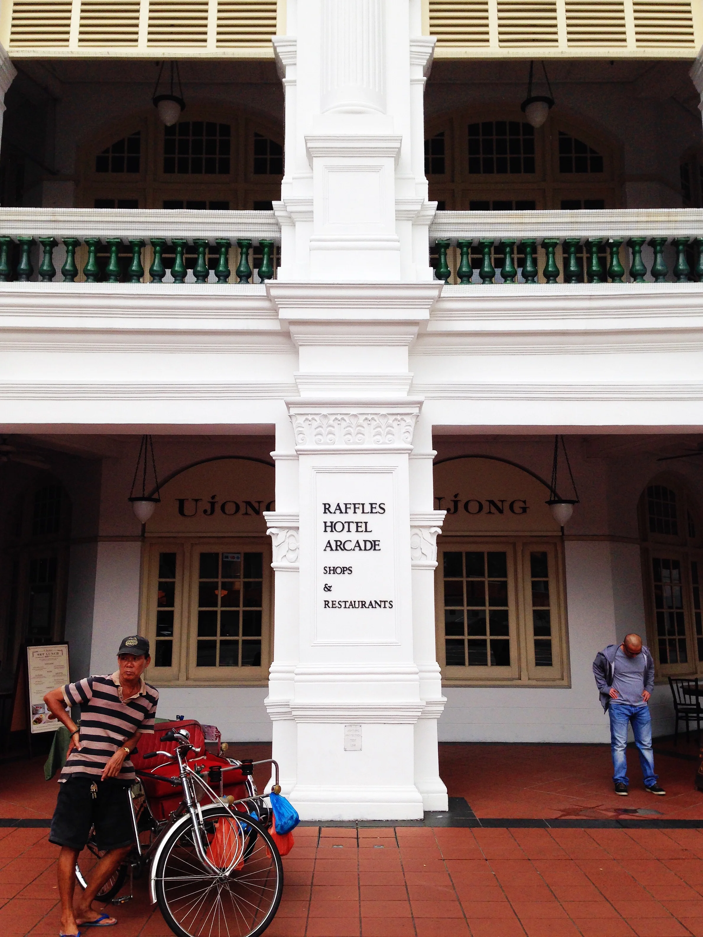 Rickshaw driver on duty in front of the Raffles