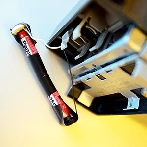 Tape the two AAA batteries together then tape the white wires connector to the positive and the black wires connector to the negative