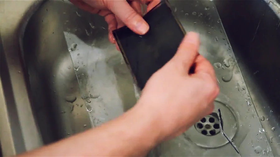 Once you have removed all the gunk from one side, flip it over but be sure to only use warm water on this more delicate side.