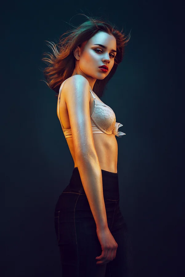 This image was taken of a singer who was was much shorter than the typical 5’10" height of a professional model. I was sitting on the floor looking up at her with my 50mm lens and from this angle I was able to utilize the lens distortion to make her appear taller and more dominant in the image.