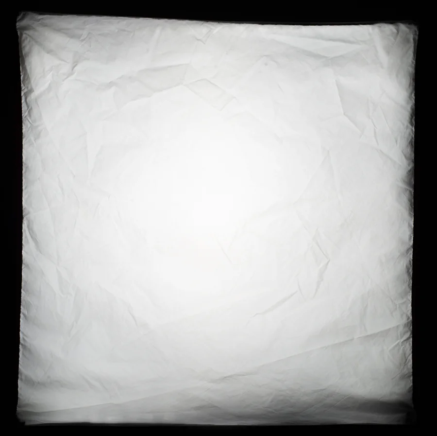 This is a stopped down shot of the front of my 60cmx60cm softbox when the flash is fired. It clearly shows that the centre of it is brighter than the edges and this brighter centre point is referred to as the 'hotspot'.