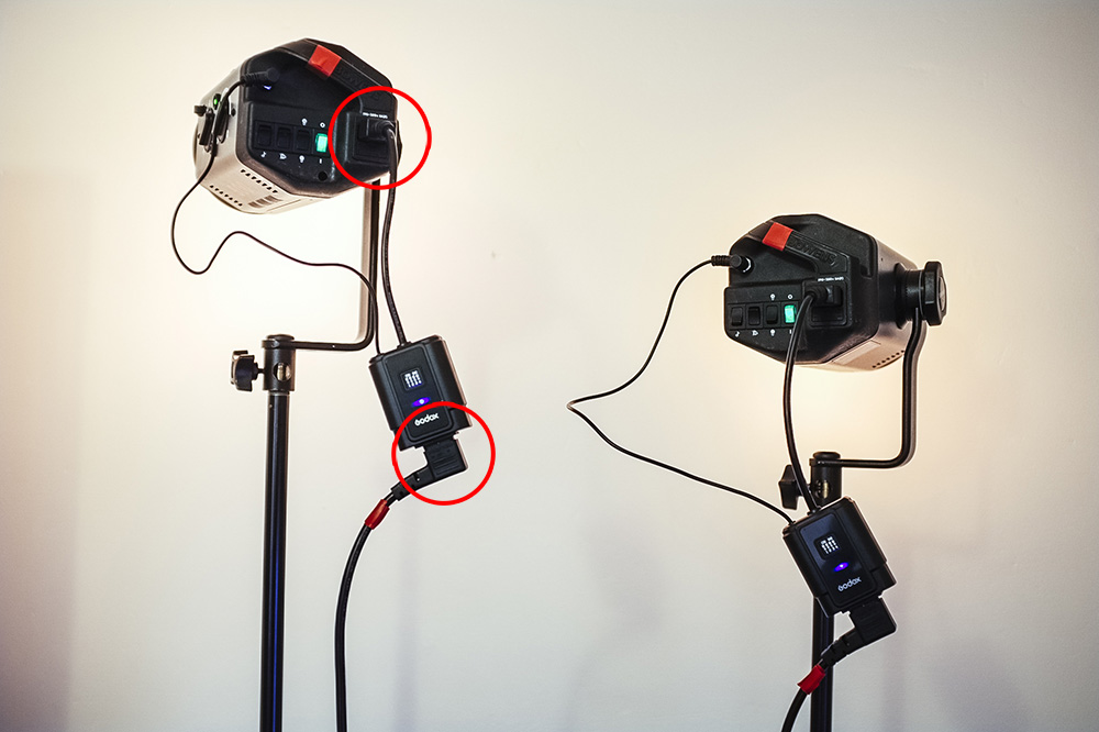 The Godox receivers plugs straight into the flash heads power socket and then you plug the power directly into that. This negates the need for additional batteries.