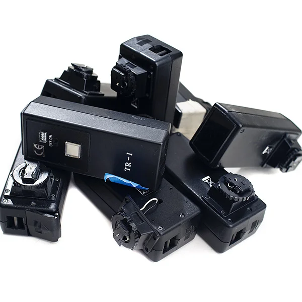 I've gone through my fair share of infrared triggers over the years and although they are ugly as all hell they are thankfully relatively inexpensive. They sit on the cameras hotshoe and send out an infrared signal to fire the flashes whenever you press the shutter.