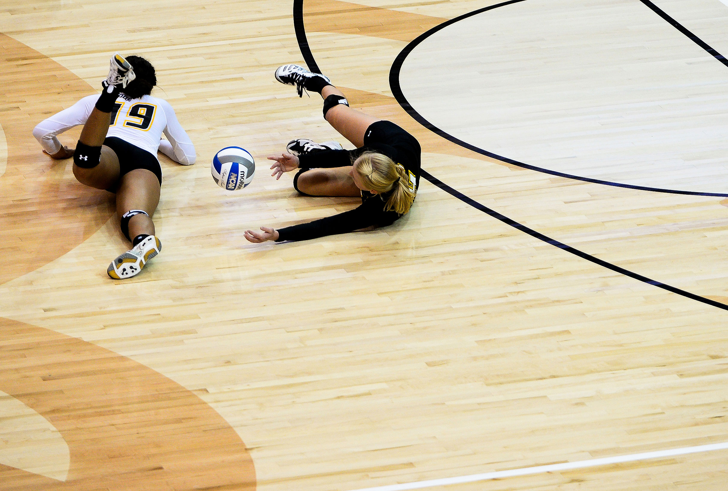  Towson University volleyball players attempt to dive for a ball during 
their home opener against Coppin State University in Baltimore, MD on Sept. 3, 2013.  